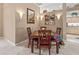 Cozy dining area boasts a wooden table, plush seating, and stylish wall decor at 686 Silk Oak Dr, Venice, FL 34293