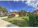Attractive single-story home features landscaped lawn with palm trees and a driveway under a bright blue sky at 686 Silk Oak Dr, Venice, FL 34293