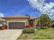 Charming single-story home features a tile roof, two-car garage, and well-maintained landscaping at 686 Silk Oak Dr, Venice, FL 34293