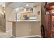 Kitchen includes a breakfast bar, cabinets, and modern appliances at 686 Silk Oak Dr, Venice, FL 34293