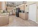 Spacious kitchen with stainless steel appliances, tile flooring, and light wood cabinetry at 686 Silk Oak Dr, Venice, FL 34293