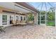 Spacious screened lanai features brick pavers, comfortable seating, and an inviting outdoor living space at 686 Silk Oak Dr, Venice, FL 34293