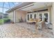 Inviting screened lanai with comfortable seating and a brick-paved floor for outdoor relaxation at 686 Silk Oak Dr, Venice, FL 34293