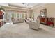 Inviting living room showcases neutral tones, ceiling fan, and access to outdoor space at 686 Silk Oak Dr, Venice, FL 34293