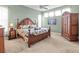 Main bedroom featuring ceiling fan, tropical themed decor, and a large wardrobe at 686 Silk Oak Dr, Venice, FL 34293