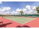 Outdoor tennis court features green and red playing surfaces with seating available for those watching the game at 686 Silk Oak Dr, Venice, FL 34293