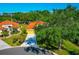 Beautiful landscaping, a manicured lawn, and a yellow two-story home can be seen in this aerial view at 7035 Owls Nest Ter, Bradenton, FL 34203