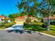 Inviting home featuring a red tile roof, meticulously landscaped yard, and a spacious two-car garage at 7035 Owls Nest Ter, Bradenton, FL 34203