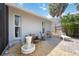Paver patio area featuring a fountain, mature landscaping, and several seating options at 711 Birdsong Ln, Sarasota, FL 34242