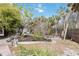 Landscaped backyard space featuring mature landscaping and brick pavers at 711 Birdsong Ln, Sarasota, FL 34242