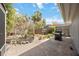 Backyard space featuring mature landscaping, brick pavers, and an outdoor grill at 711 Birdsong Ln, Sarasota, FL 34242