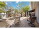 Landscaped backyard space featuring mature landscaping, brick pavers, and seating areas at 711 Birdsong Ln, Sarasota, FL 34242