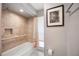 Bathroom featuring tub with tile surround, and shower and safety bars at 711 Birdsong Ln, Sarasota, FL 34242