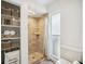 Well-lit bathroom with shower and built-in shelving for extra storage at 711 Birdsong Ln, Sarasota, FL 34242
