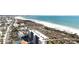 Coastal view featuring a pristine beach next to modern beachfront condos and townhomes at 711 Birdsong Ln, Sarasota, FL 34242
