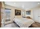 Bright bedroom with wood-look flooring, cozy furnishings and natural light at 711 Birdsong Ln, Sarasota, FL 34242