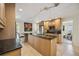 Open kitchen with a large island, granite countertops, stainless appliances, and breakfast bar at 711 Birdsong Ln, Sarasota, FL 34242