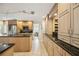 Spacious kitchen with granite countertops, stainless steel appliances, and light wood cabinetry at 711 Birdsong Ln, Sarasota, FL 34242