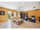 Spacious living room featuring stylish furniture, ceiling fan, and natural light at 711 Birdsong Ln, Sarasota, FL 34242