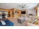 Bright living room with stylish furniture, a large ceiling fan, and an adjacent dining area and kitchen at 711 Birdsong Ln, Sarasota, FL 34242