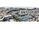 An aerial view shows tennis courts and ample parking near a scenic pond at 711 Birdsong Ln, Sarasota, FL 34242