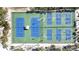 Aerial view of well-maintained blue and green tennis and pickleball courts in a scenic outdoor setting at 711 Birdsong Ln, Sarasota, FL 34242
