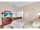 Bedroom featuring carpet, a wooden bedframe, white bedding, and a TV stand at 7116 Drewrys Blf, Bradenton, FL 34203