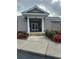 Exterior shot of the clubhouse entrance with flowers and steps at 7116 Drewrys Blf, Bradenton, FL 34203