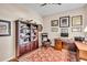 Cozy home office with wood floors, built-in bookcase, desk, and comfortable leather chair at 7116 Drewrys Blf, Bradenton, FL 34203