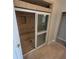 Tile shower featuring sliding glass doors with a small window and tile bench seat at 835 Indiana Ln, Sarasota, FL 34234