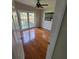 Bedroom featuring hardwood floors, fan, french doors to the yard, and a bright window at 835 Indiana Ln, Sarasota, FL 34234