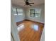 Bedroom with hardwood floors, fan, and a bright window at 835 Indiana Ln, Sarasota, FL 34234
