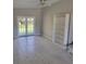 Bright room featuring hardwood floors, french doors, a bookshelf and neutral colored walls at 835 Indiana Ln, Sarasota, FL 34234