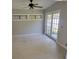 Bright living room featuring french doors, white painted hardwood floors and neutral walls at 835 Indiana Ln, Sarasota, FL 34234