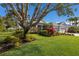 Lovely home with a sprawling lawn, mature trees, and vibrant landscaping, plus an attached two-car garage at 8850 17Th Avenue Nw Cir, Bradenton, FL 34209