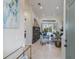 Bright living room featuring neutral tones, tile floors, stylish furnishings, and sliding glass doors to the lanai at 8850 17Th Avenue Nw Cir, Bradenton, FL 34209