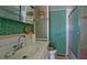 The bathroom includes a vanity with sink, toilet, and shower with glass door, exuding classic charm at 10315 Cortez W Rd # 8Bv, Bradenton, FL 34210