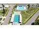 Aerial shot showing community amenities including a pool, shuffleboard and tennis courts, and lush greenery at 10315 Cortez W Rd # 8Bv, Bradenton, FL 34210