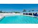 Clear, inviting community pool with nearby lounging area at 10315 Cortez W Rd # 8Bv, Bradenton, FL 34210