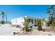 Single-story home featuring tidy landscaping, trees, and a nearby water view at 10315 Cortez W Rd # 8Bv, Bradenton, FL 34210