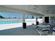 Poolside patio area with tables and chairs, overlooking the pool at 10315 Cortez W Rd # 8Bv, Bradenton, FL 34210
