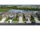 Desirable neighborhood showcasing single-Gathering homes with verdant lawns and a stunning lake view, ideal for suburban living at 10459 Ladybug Cove, Parrish, FL 34219