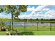 Scenic backyard view showcasing a tranquil lake and lush greenery, perfect for relaxation and enjoying nature at 10459 Ladybug Cove, Parrish, FL 34219