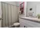 Neutral bathroom featuring a shower, white vanity, and decorative accents at 10459 Ladybug Cove, Parrish, FL 34219