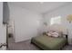 A calming bedroom with carpet, a bed with a headboard, and a decorative mirror at 10459 Ladybug Cove, Parrish, FL 34219