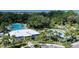 Aerial view showcasing a community pool, splashpad, and playground nestled among lush trees and landscaping, perfect for families at 10459 Ladybug Cove, Parrish, FL 34219