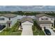 Inviting single-story home showcasing a well-manicured lawn and colorful flowerbeds, with a serene lake view beyond at 10459 Ladybug Cove, Parrish, FL 34219