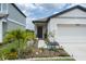 Charming home featuring a well-manicured lawn with colorful flowerbeds, and a welcoming front entrance at 10459 Ladybug Cove, Parrish, FL 34219