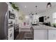 Modern kitchen boasts granite countertops, stainless appliances, and open layout to living area at 10459 Ladybug Cove, Parrish, FL 34219