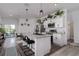 Stylish kitchen with a center island, stainless steel appliances, white cabinets, and modern light fixtures at 10459 Ladybug Cove, Parrish, FL 34219